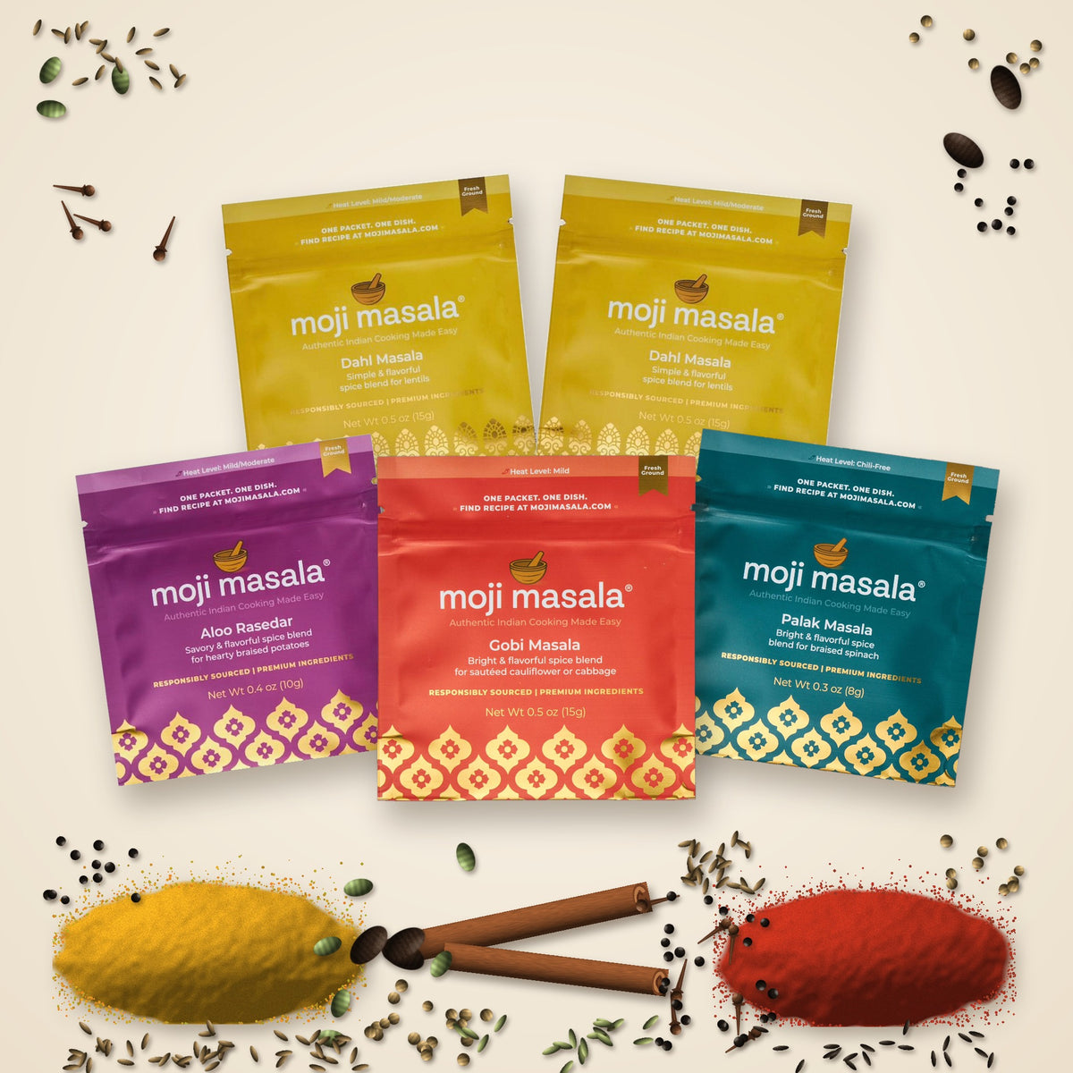 Everyday Dahl Set packets surrounded by whole spices: cinnamon, cardamom, cloves and peppercorns