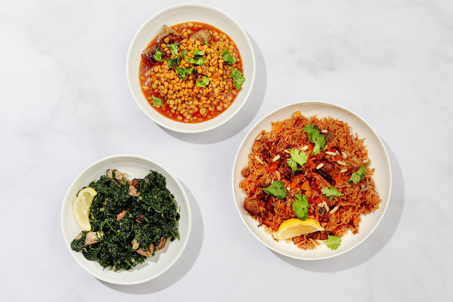 Three bowls of different dishes on a white background